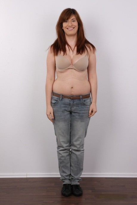 Chubby redhead Martina strips naked before a close-up of her muff