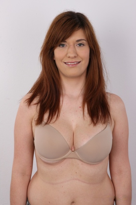 Chubby redhead Martina strips naked before a close-up of her muff