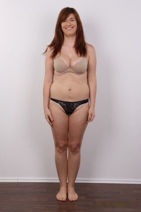 Chubby redhead Martina strips naked before a close-up of her muff