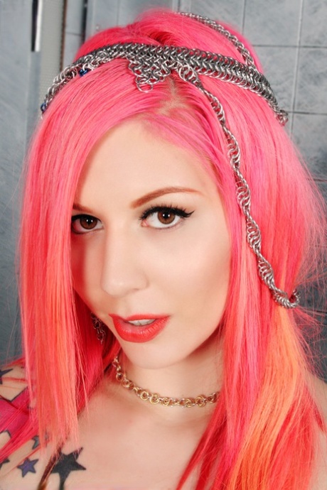 Solo girl with dyed haired Annalee Belle shows her tattooed body in the nude