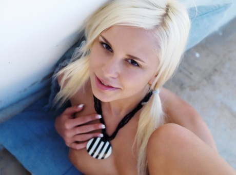 Gorgeous blonde teen Dido goes nude on throw cushions in a pair of heels