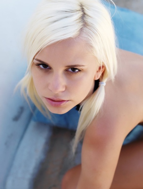 Gorgeous blonde teen Dido goes nude on throw cushions in a pair of heels