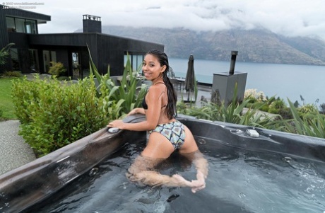 Solo girl Jasmine Summers gets naked in a backyard before hot tub action