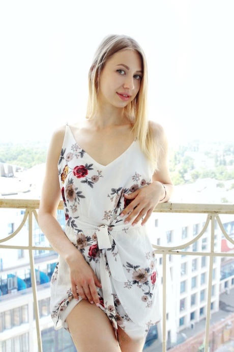 Nice teen Dominica slips off a summer dress to pose in the nude
