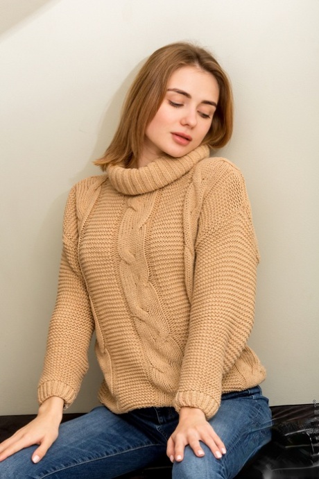 Young redhead Alice Shea removes jeans and sweater to model in the nude