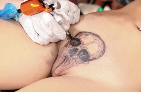 Dark haired girl Selena Savage has her pussy tattooed before MMF sex