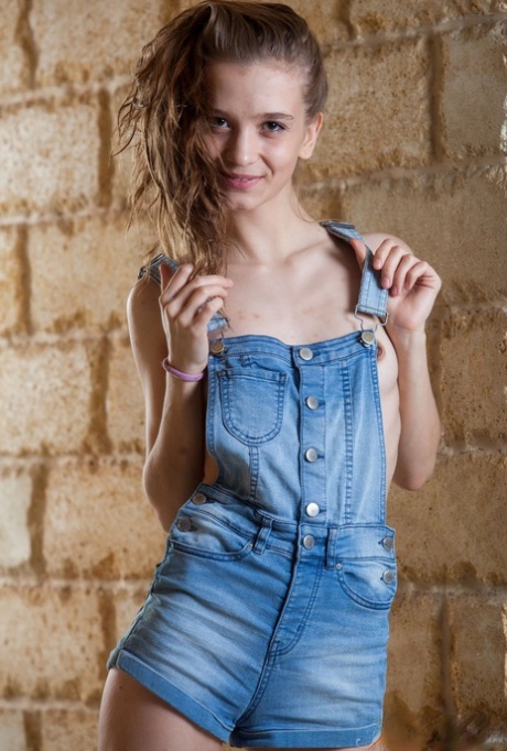 Barely legal girl Alisabelle rubs oil into her still developing breasts