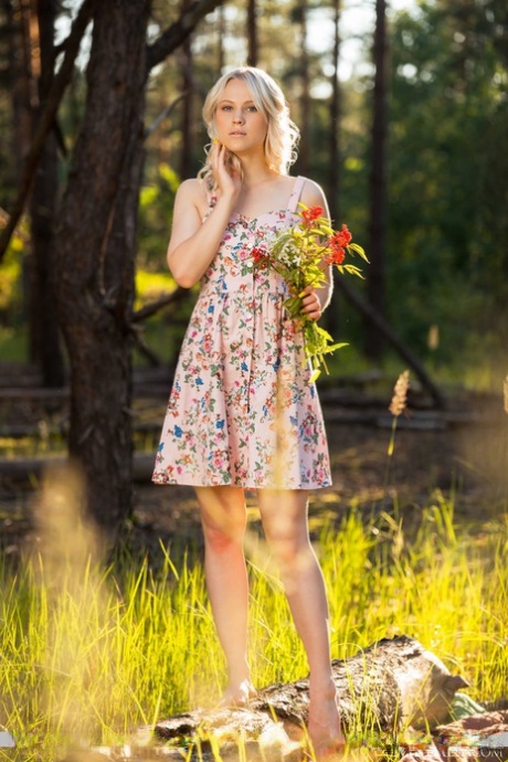 Young blonde Nikki Hill gets naked on in the woods while eating a watermelon