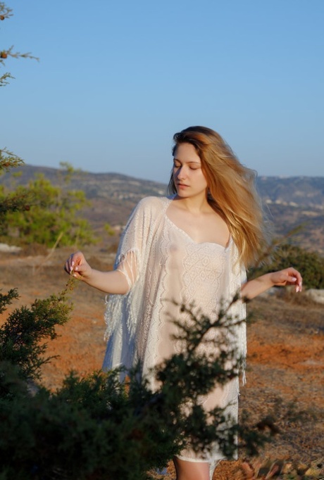 Young redhead Katty Muss models sheer attire prior to showering in the nude