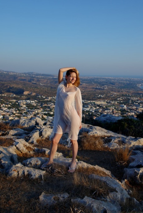 Young redhead Katty Muss models sheer attire prior to showering in the nude