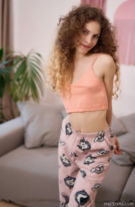Young girl with curly hair and a sweet pussy Lisa Bon gets totally naked