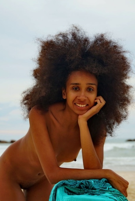 Ebony teen Isadora sports big hair while posing nude at the beach