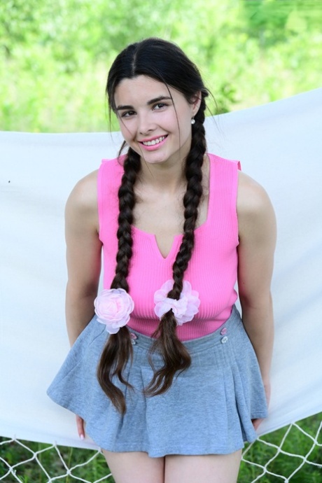 Brunette teen Sofa wears her hair in pigtails well going nude on a hammock