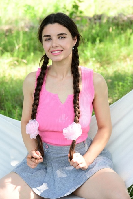 Brunette teen Sofa wears her hair in pigtails well going nude on a hammock