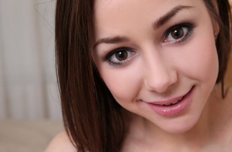 Naked teen girl spreads her legs to better display her bald snatch
