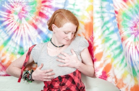 Redhead punk chick Isadora fondles all natural boobs and fingers hairy twat