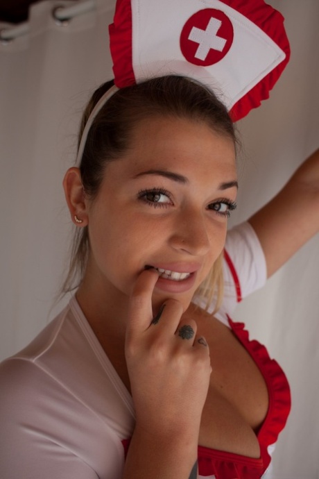 Blonde nurse Jenna Ashley takes off her uniform and reveals her tight ass