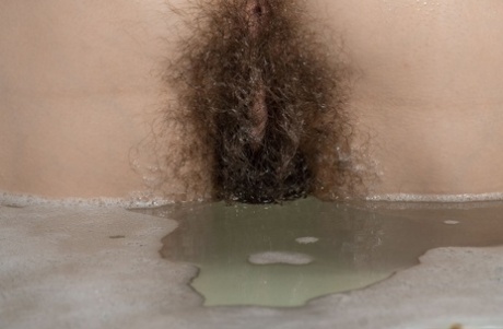 Short-haired beauty Calina washing her big ass & hairy pussy in the bathtub