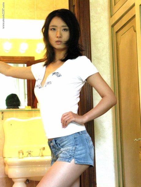 Asian pornstar Elisa reveals her hairy crotch and poses naked in a solo