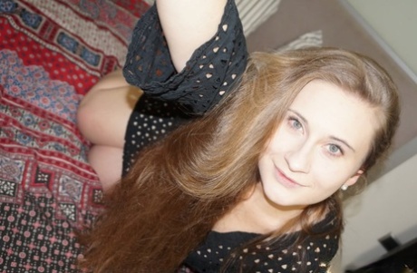 Long-haired American amateur poses naked on her bed while taking sexy selfies