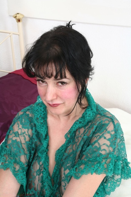 Mature brunette Andrea strips naked & spreads her breathtaking hairy pussy