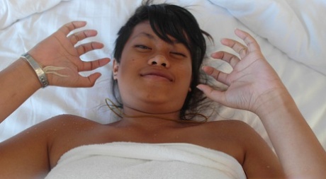 Beautiful Asian babe Paw shows her trimmed puffy pussy up close