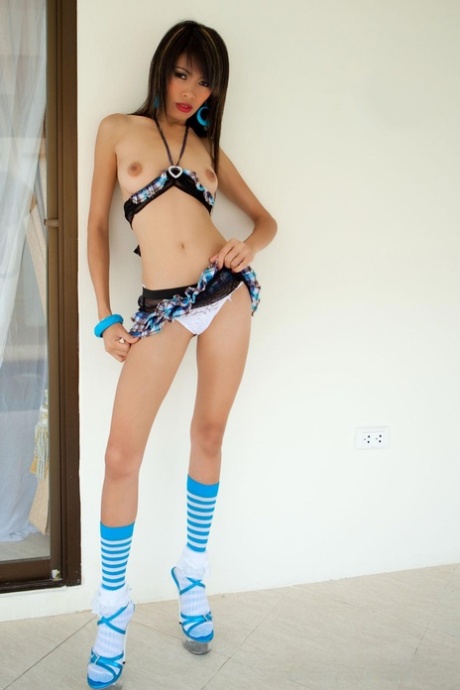 Petite Thai sweetheart Fai strips to her sexy socks & heels & poses
