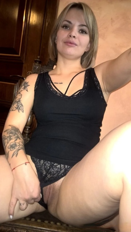 Blonde babe shows her small tits  her shaved pussy in black lingerie