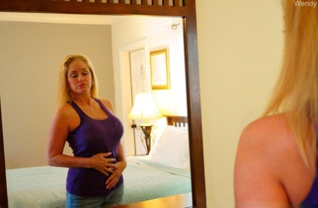 Sexy amateur MILF Wendy goes topless in the mirror & teases with her big tits