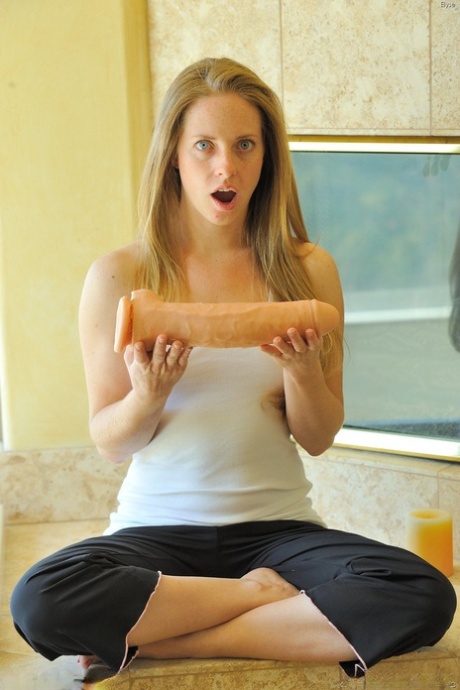 Sweet blonde Elyse exposes her tiny tits and rides giant sex toys