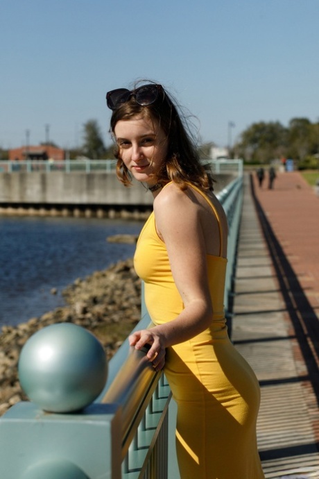 Naughty amateur flashes a pantyless upskirt and her natural tits outdoors
