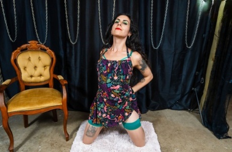 Inked brunette shemale Octavia Fox exposes her long cock and poses